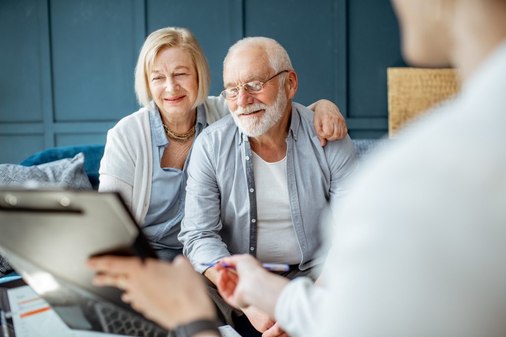 Senior couple with consultant at the office