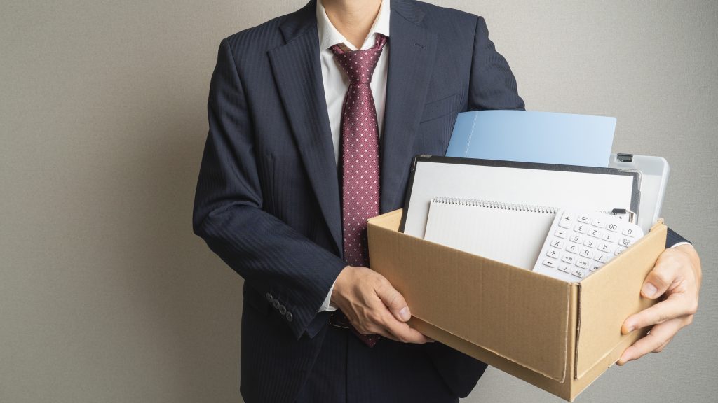 Man holding a box with papers at work