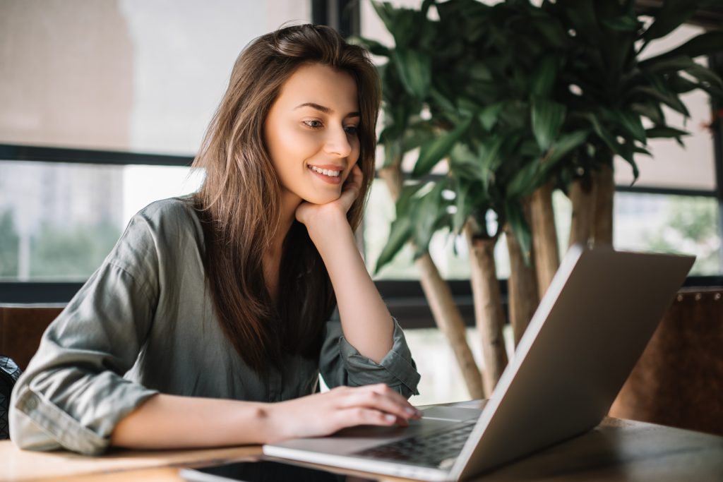 Successful freelancer typing on keyboard using laptop computer i